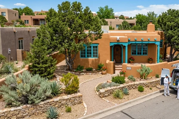 Example of a professionally painted Santa Fe, NM home with desert landscape and features- stucco finished, HDRB compliant, beautifully finished by local painting experts.